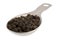Measuring tablespoon of black peppercorns