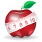 Measuring tape around fresh red apple