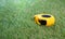 Measuring tape lies on the artificial grass lawn