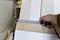Measuring the width wooden Panel using a construction tape. Medium Density Fiberboard (MDF). Woodworking industry and furniture