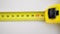 Measuring yellow tape measure scale with centimeters on wooden boards for marking the place of cutting. Lumber, house