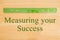 Measuring your Success message with a plastic ruler on a desk