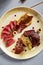 Meat appetizer in beige ceramic plate