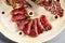 Meat appetizer in beige ceramic plate