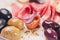 Meat appetizer selection. Salami, prosciutto, bread sticks, baguette, olives and sun-dried tomatoes, selective focus.