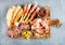 Meat appetizer selection or wine snack set. Variety of smoked meat, salami, prosciutto, bread sticks, baguette, olives