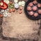 Meat balls with herbs and onions in a pan with tomatoes, peppers, zucchini and herbs on wooden rustic background top view close up