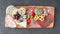 Meat board - mortadella, prosciutto, bresaola, gorgonzola, grapes, taralli, pate, red pepper, green olives, rosemary and basil on