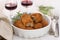Meat croquettes in dish and red wine