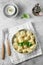 Meat dumplings - russian pelmeni, ravioli with meat on a white plate. Flat lay composition