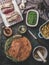 Meat food background. Cooking preparation with raw lamb meat, green green peas , back potatoes and rosemary bread crust on rustic