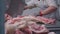 Meat industry, a worker cuts a part of the carcass with a saw, cuts meat