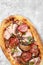 Meat Italian pizza with roast beef, steak slices, melted cheese, with olive slices and cheddar cheese. Close up, macro