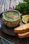 Meat in jelly, toasted bread and fresh vegetables on wooden table