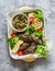 Meat kebab , grilled vegetables sauce, zucchini, flatbread, green salad - a delicious mediterranean style lunch on a gray