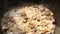 Meat and onions are stewed in a cauldron in a sauce close-up. Cooking pilaf in a cast-iron kazan, zirvak, oriental cuisine. Step 3