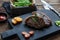 Meat Picanha steak, traditional Brazilian cut on black cutting board.