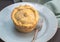 Meat pie on small plate close up - Quaint home made single pie b