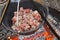 Meat pieces in a cauldron.food on the fire. Cooking meat in a cauldron.Cooking outdoors.Camping cooking.Wood fire and