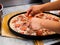 Meat pizza being assembled