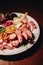 Meat plate: sausage, bacon, savory appetizers and sauces