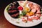 Meat plate: sausage, bacon, savory appetizers and sauces