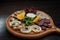 Meat platter: chicken roll, jerky, salami sausage, pork. Dish is decorated with fresh orange slices