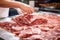 Meat processing plant. A worker sorts cold cuts on a conveyor belt. Arrival of jamon or cold cuts. Production of pork or beef in a