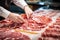 Meat processing plant. A worker sorts cold cuts on a conveyor belt. Arrival of jamon or cold cuts. Production of pork or beef in a