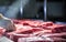 Meat processing or quality control process in the food industry environment.