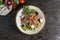 Meat salad with roast beef and feta cheese. Cold appetizer of lettuce leaves, cherry tomatoes, beef, veal or pork, feta cheese and