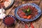 Meat and sausage cuts, garlic, chili peppers, tomatoes and other spices on a wooden brown background