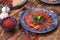 Meat and sausage cuts, garlic, chili peppers, tomatoes and other spices on a wooden brown background