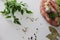 Meat sausages with seasonings, spices with parsley and garlic and lemon on a light table