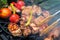 Meat skewered and vegetables on grill grate