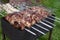 Meat on skewers is cooked in the garden