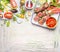 Meat skewers with fresh herbs, spices and vegetables ingredients for grill or cooking. Preparation on light wooden background, top