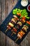 Meat skewers - grilled meat with vegetables on wooden background