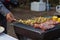 Meat and skewers ingredients for barbecue party are placed on grill to cook barbecue and make it ready for family to join barbecue