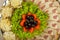 Meat sliced on a mirror dish decorated with verdure.