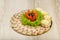 Meat sliced on a mirror dish decorated with verdure.