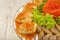 Meat sliced on a mirror dish decorated with verdure.