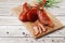 Meat smoked jerky - raw meat sausage meat. Close up view on tasty sliced Chicken basturma on parchment on a wooden board