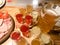 Meat snack with alcohol made from meat, ham, basturma with sauce and many glasses, shots with strong alcohol, vodka, filling