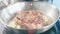 Meat steak with seasonings and herbs hissing on frying pan, close-up