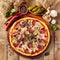 Meat and vegetable pizza on wooden table top view