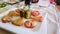 Meat and vegetable snacks. Aperitifs. Mediterranean cuisine on white tablecloth in Italian restaurant.