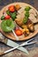 Meat with vegetables, grilled and served Italian Salsa Verde sauce. Old rustic table. Close-up