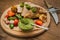 Meat with vegetables, grilled and served Italian Salsa Verde sauce. Wooden rustic table. Close-up