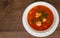 meatball tomato soup on a wooden background.